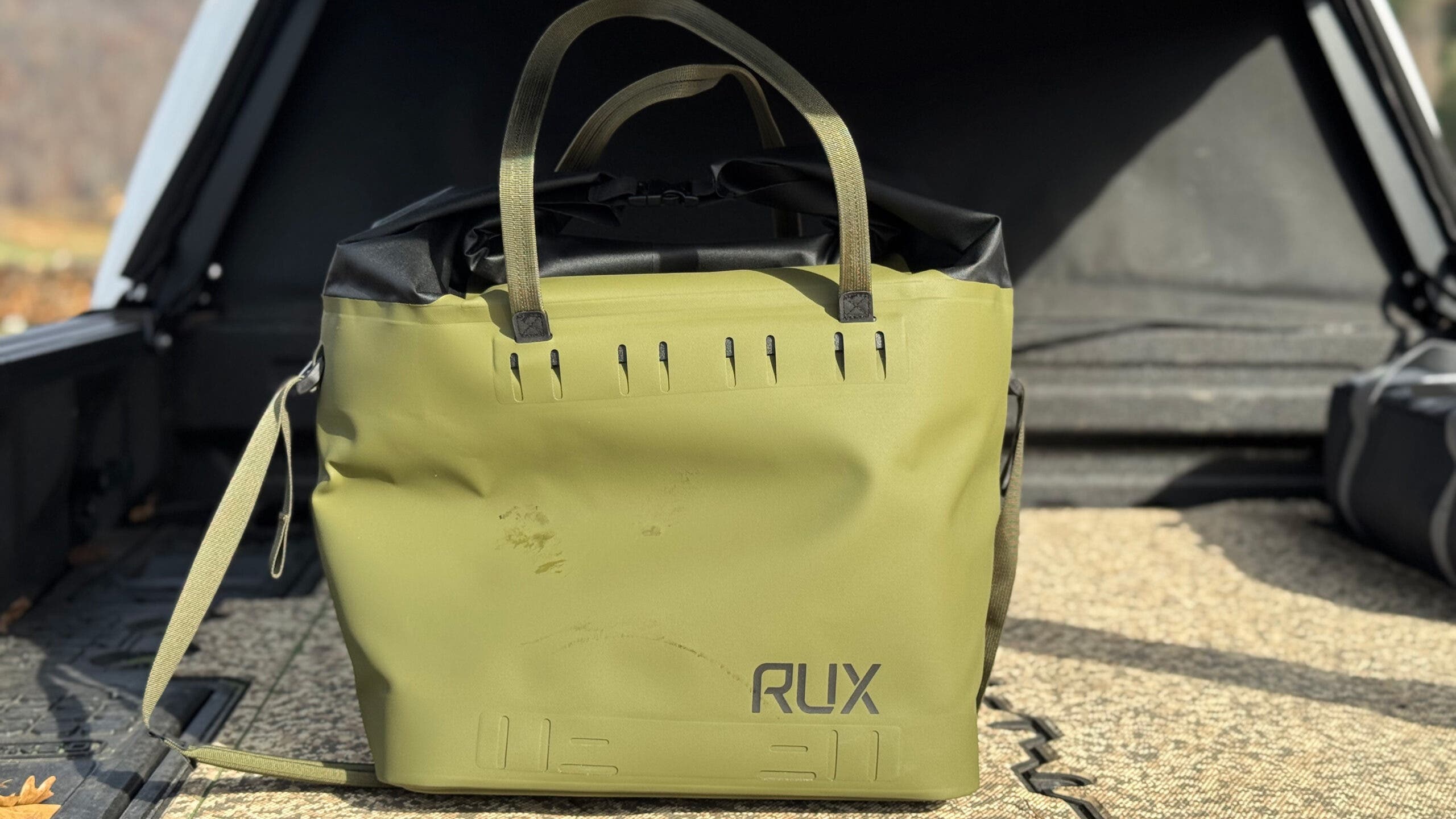 Green Rux soft cooler bag on truck bed