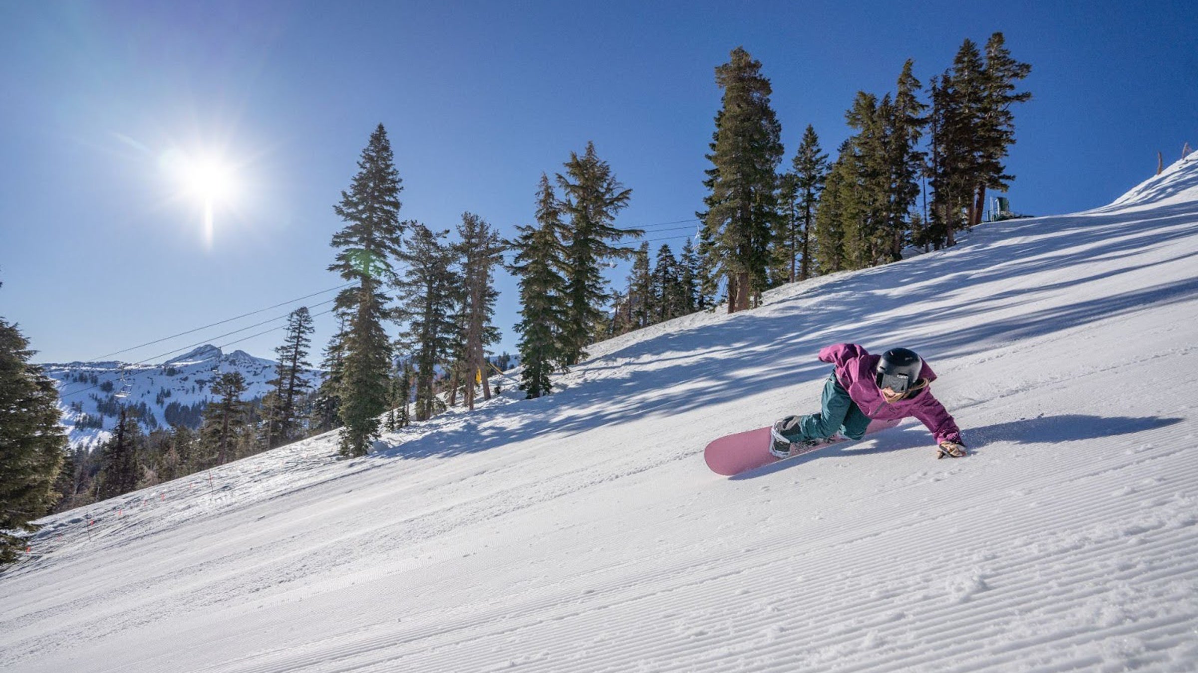 Outside snowboard tester Jenna Shlachter lays a turn on one of Kirkwood’s immaculate groomers. The riding and the views are both as good as it gets.