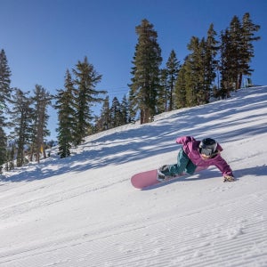 Outside snowboard tester Jenna Shlachter lays a turn on one of Kirkwood’s immaculate groomers. The riding and the views are both as good as it gets.