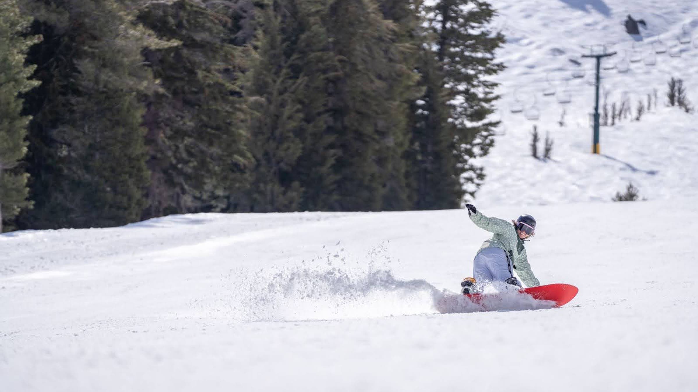Kirkwood isn’t all steeps and expert terrain. Snowboard tester Alex Grant flashes an ear-to-ear smile as she slashes down a gentle groomer.