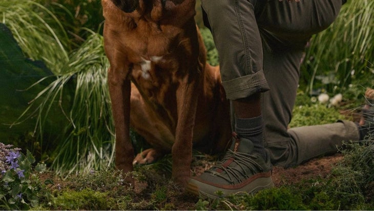 man wearing sorels with a dog