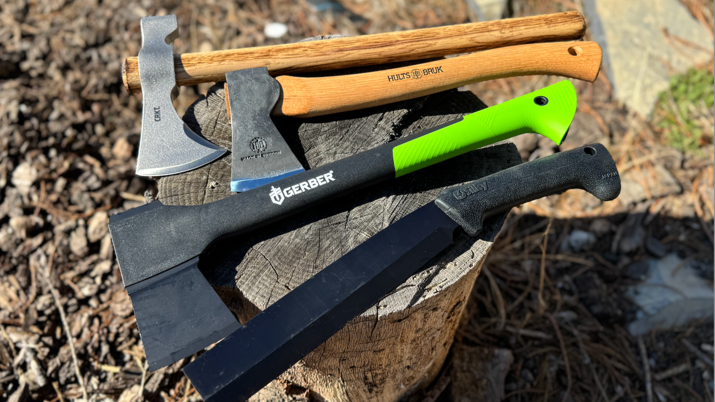 four best hatchets of various styles resting on top of tree stump outside