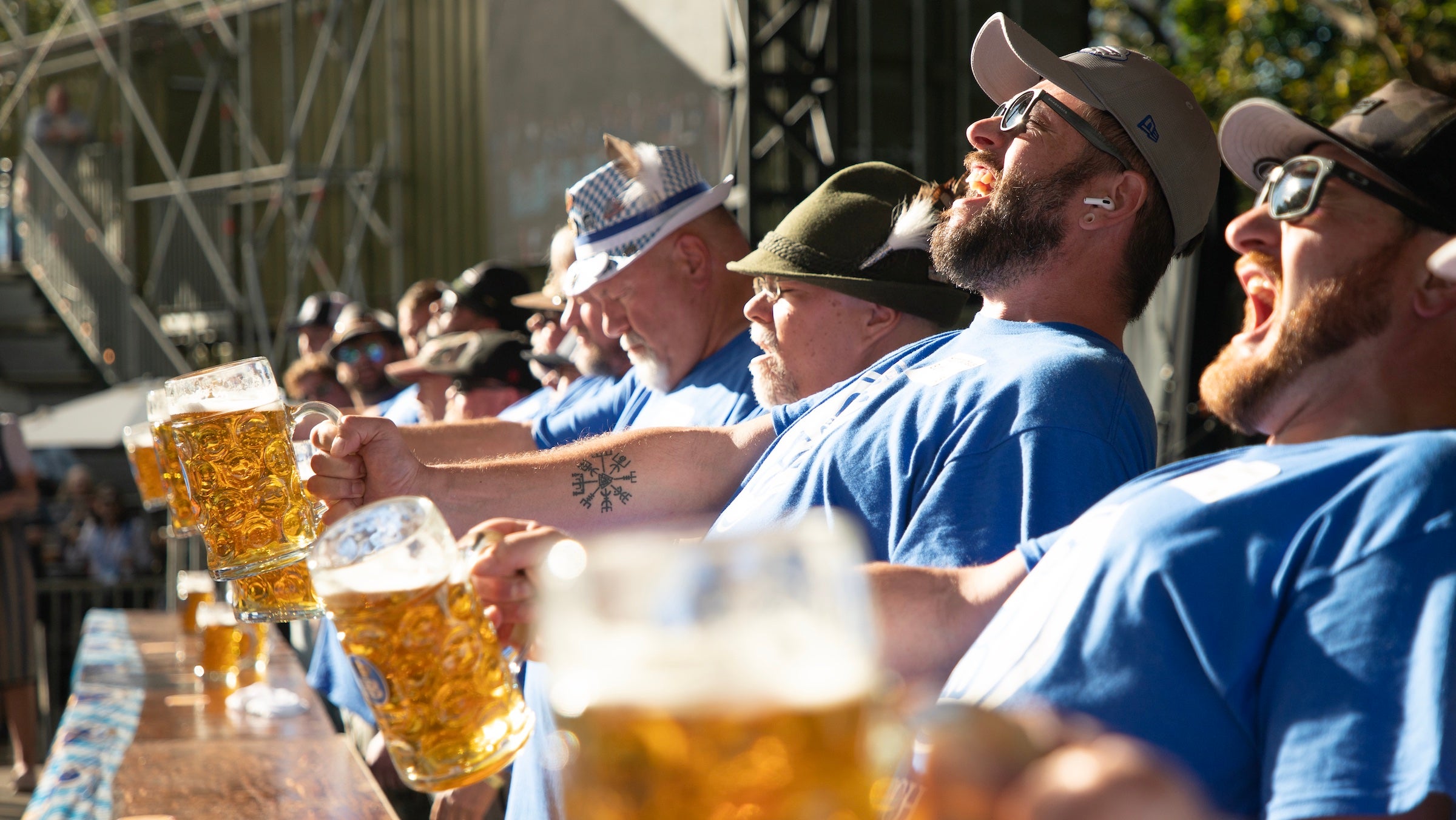 men holding beer in agony