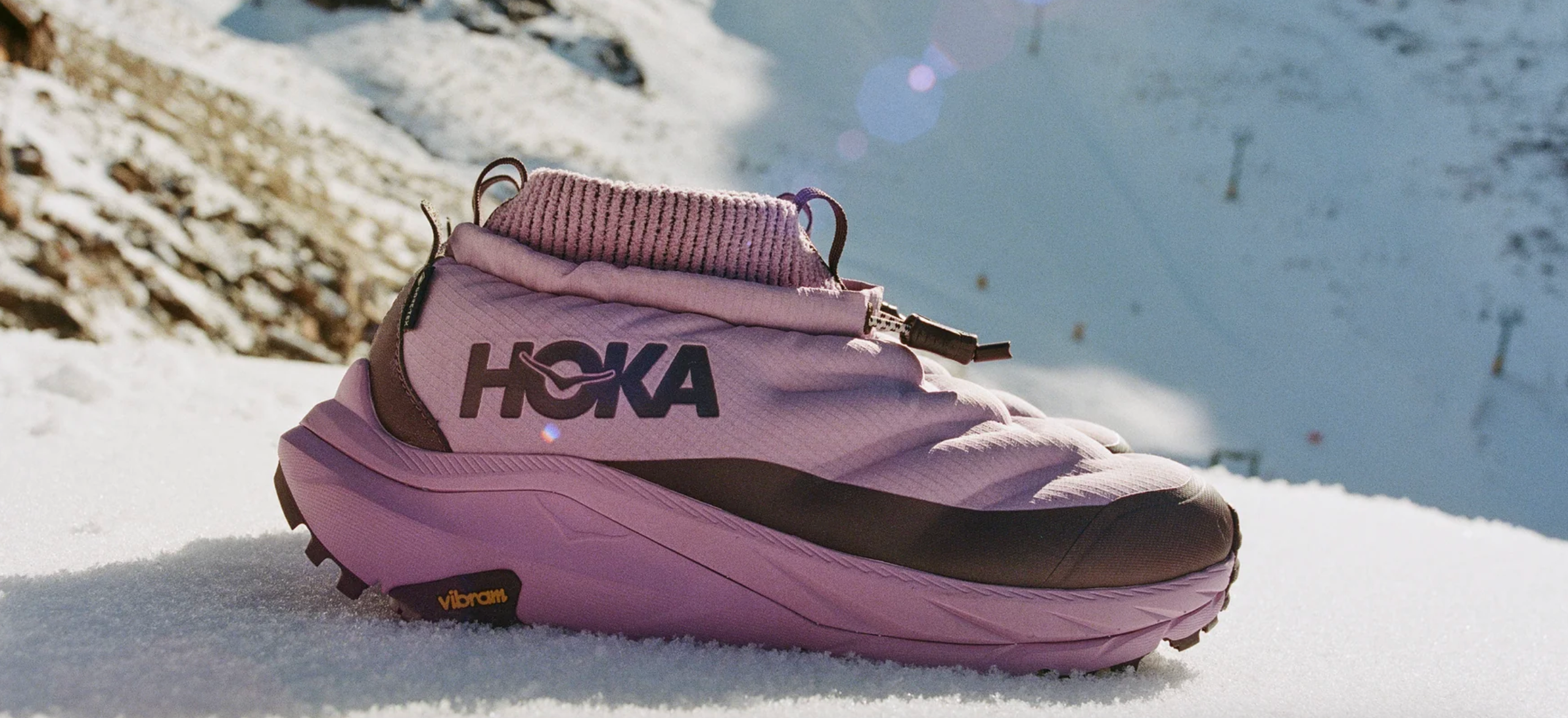 pink hoka shoes on a snowy background