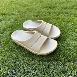The OOfos OOah Slide Sandal on grass