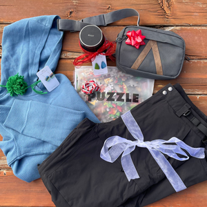 outdoors gifts laid on a wooden deck with holiday ribbons on top of them