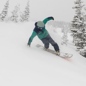 snowboarder carving on a snowy day