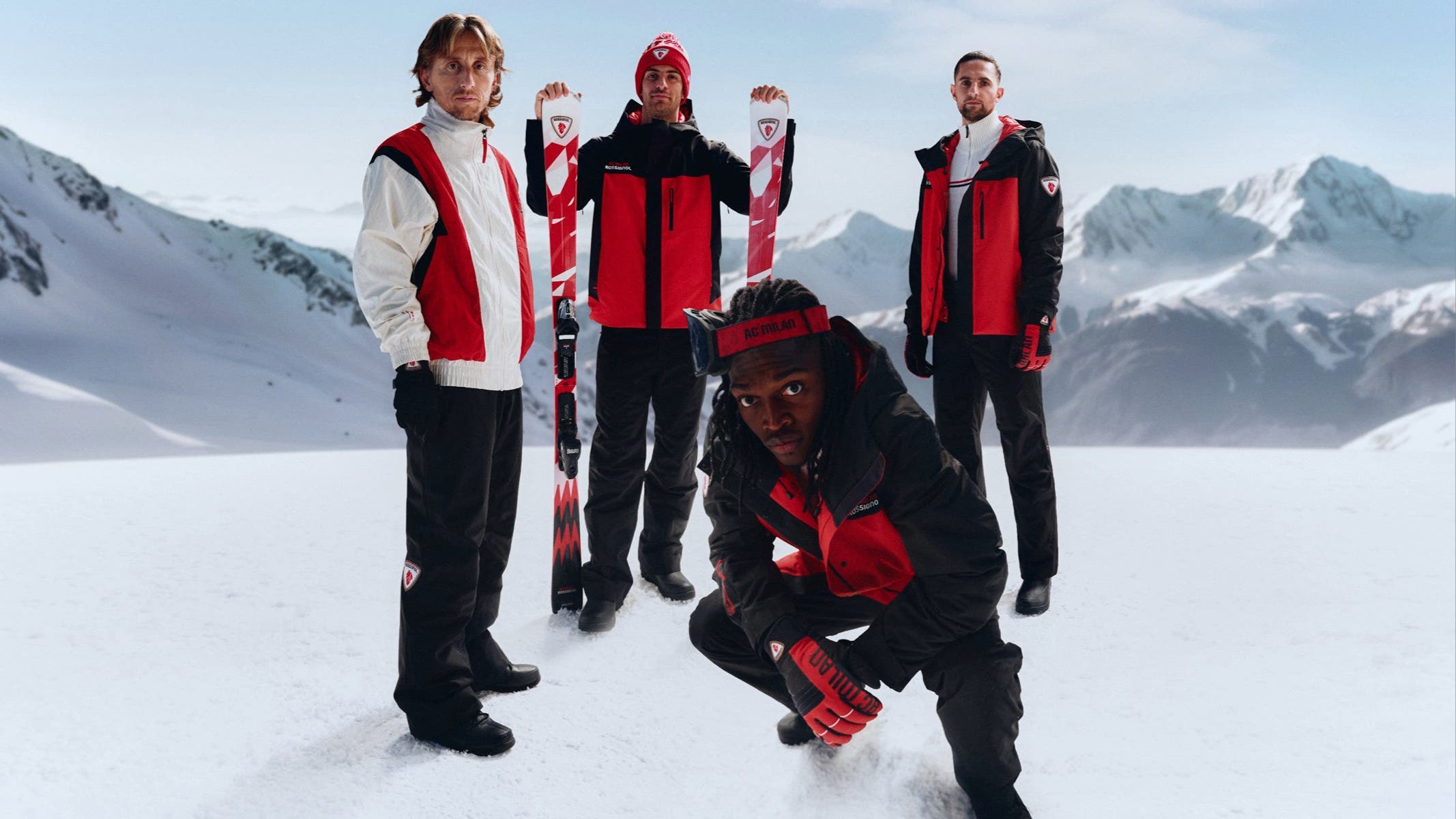 athletes in the snow wearing red and black apparel from Rossignol