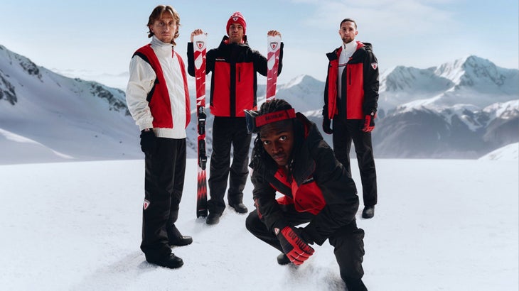 athletes in the snow wearing red and black apparel from Rossignol