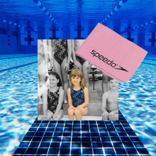 a young girl in a blue bathing suit with her swim team next to a pink speedo shammy sammy chamois towel atop a background of a lap pool underwear
