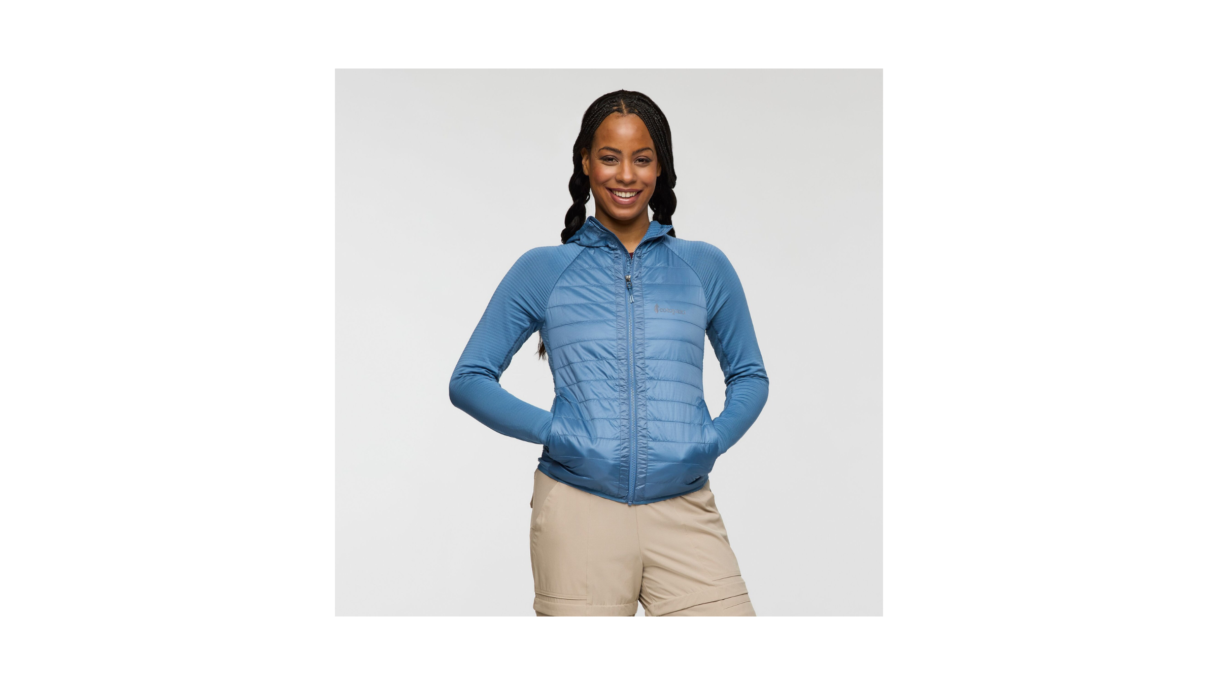 Best Winter Running Jacket for Cold and Dry Weather, the Cotopaxi Capa Hybrid Insulated Hooded Jacket - Women's, tested in 2026 by Outside. Shown on a female model in blue.