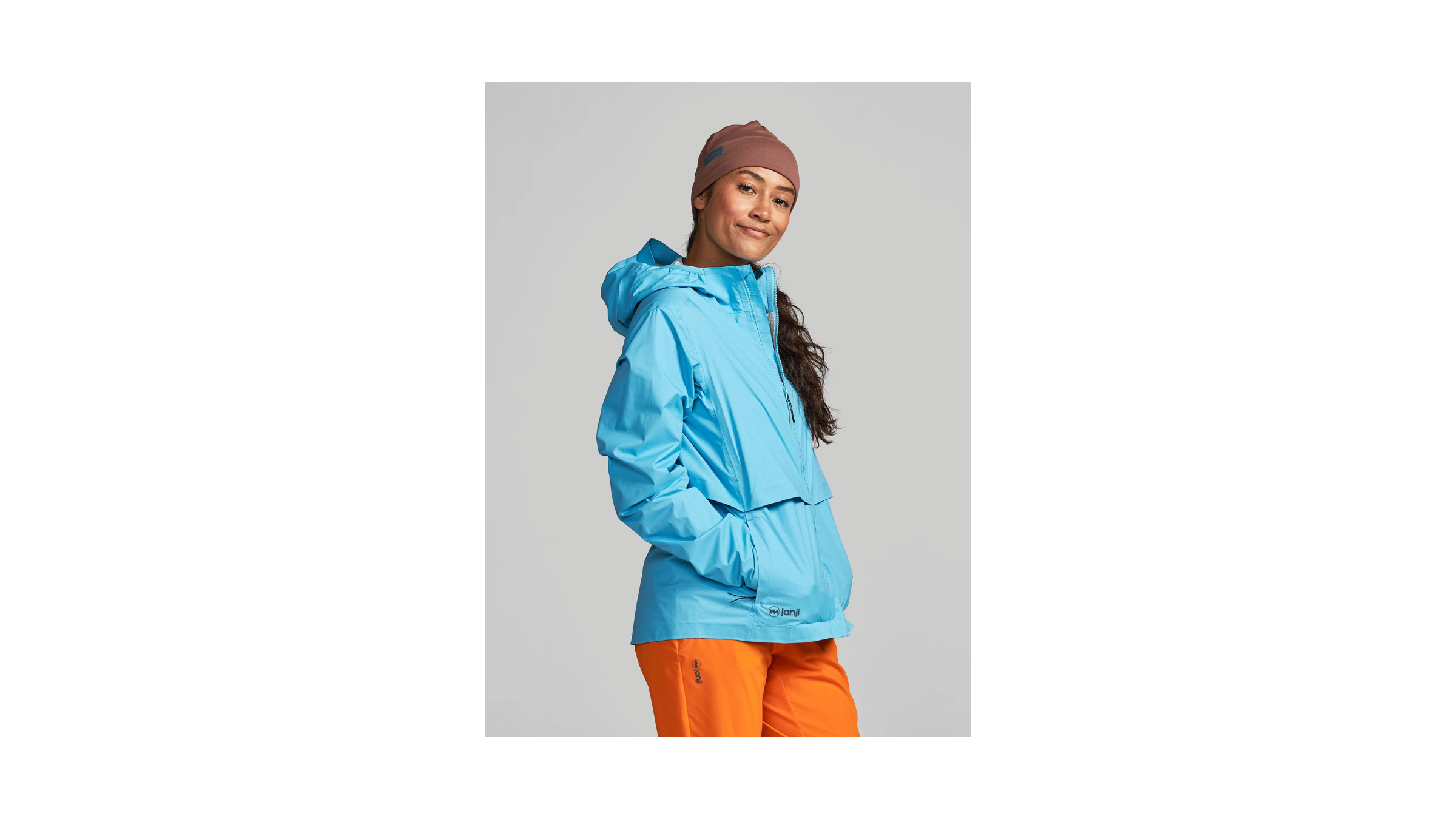 The winner of the Best Winter Running Jacket All-Around superlative in Outside's Best Winter Running Jackets for Women 2026 gear guide, Janji Rainrunner Pack Jacket 2.0. Pictured on a female model in sky blue