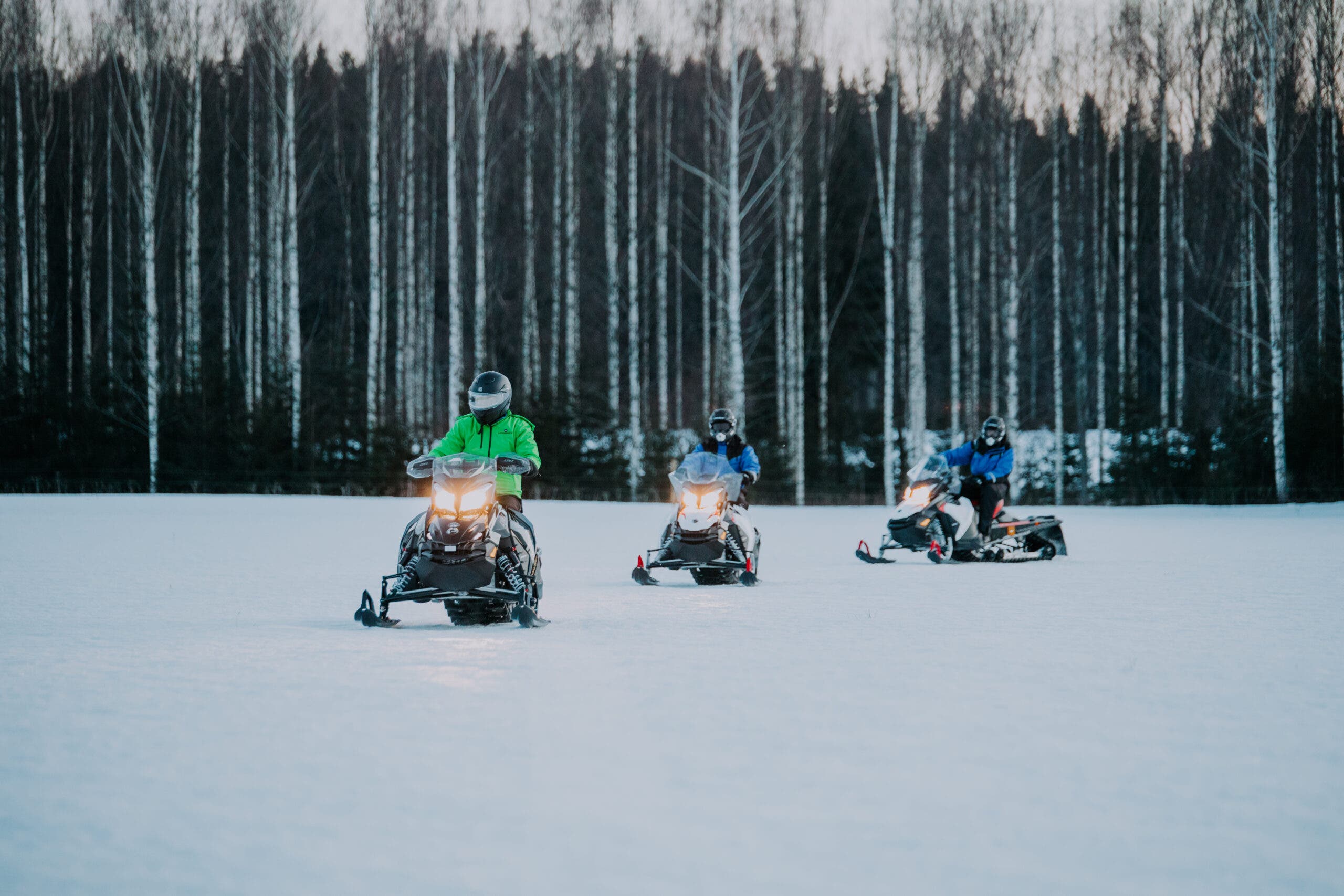 Lahti, Finland snowmobiling adventures, letting you explore snowy forests and frozen lakes like Päijänne with tour operators like Jump Up or Lehmonkärki, providing