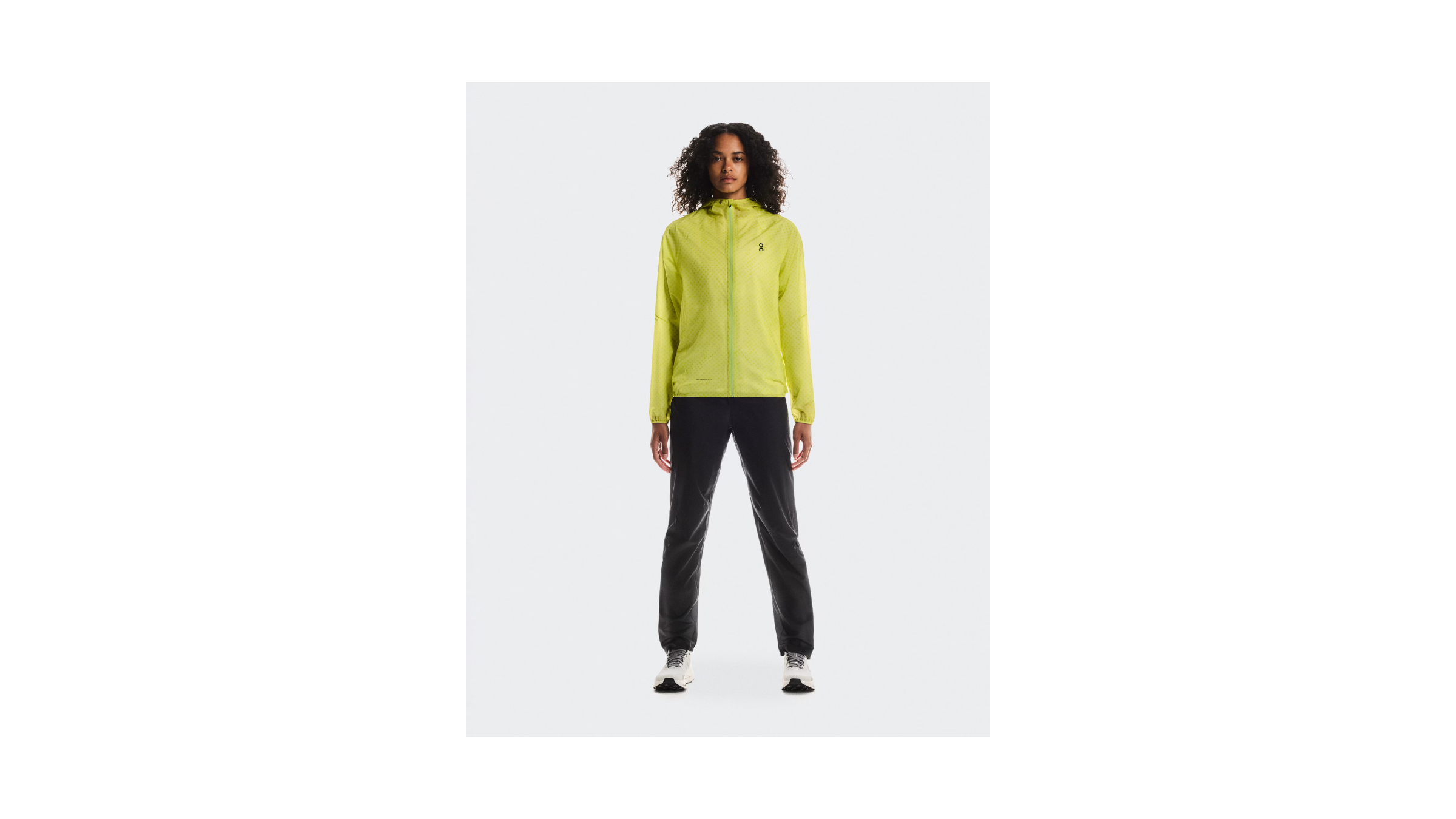 2026 Best Winter Running Jacket for Trails and Travel, the On Running Ultra Jacket, shown on a female model in lime green neon yellow