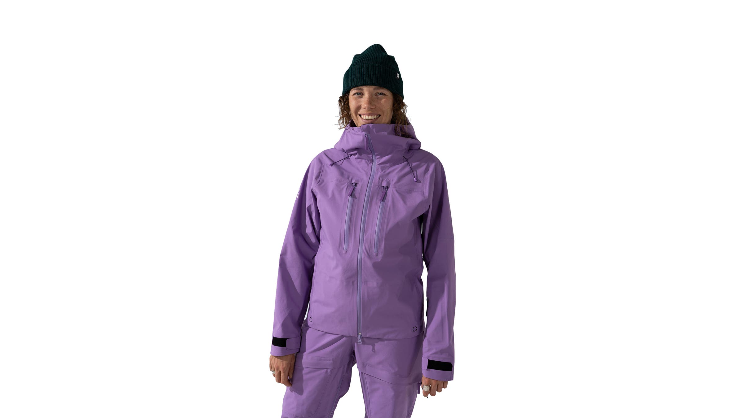 Wild Rye matching ski kit in purple worn by woman skier