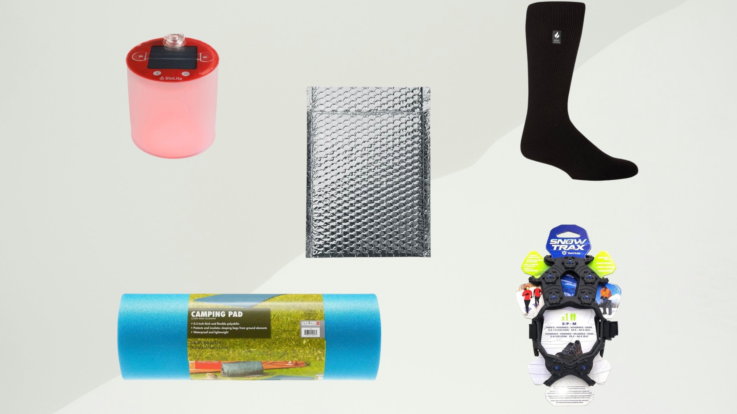 An array of cheap winter camping gear items, including a BioLite solar lantern, a silver thermal pad, a black thermal sock, a blue foam camping pad, and Snow Trax ice cleats, displayed against a neutral background.