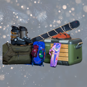 Outdoor gifts and gear, including a duffel, a cooler, ski boots, a pack, and skis wrapped in festive lights, on top of a background of twinkling lights in a forest