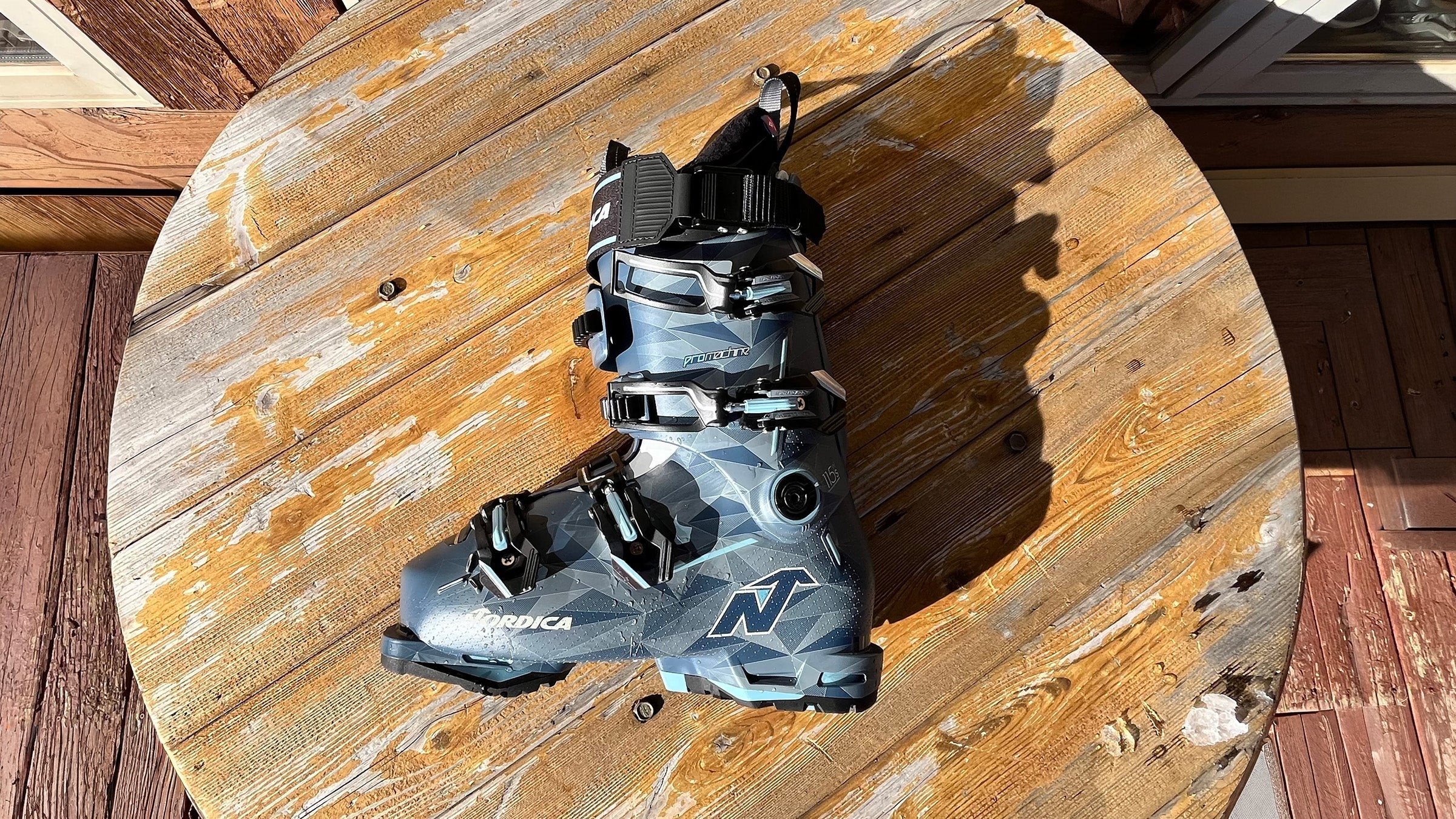 Closeup of Nordica Promachine 3 S 115 W ski boot on wooden table