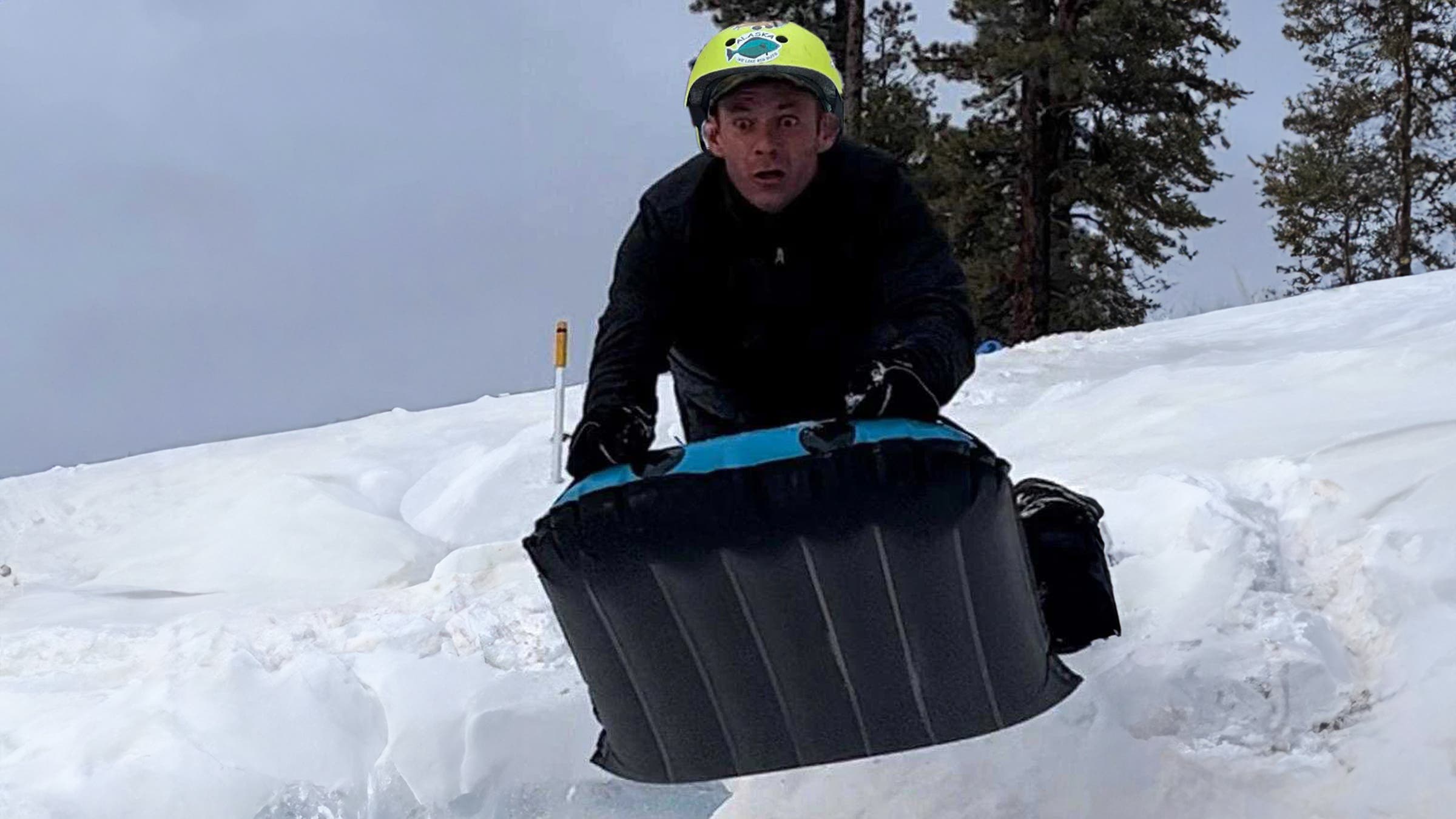 Sledder bombs down a snowy hill on the Alpacka Raft Adrenaline inflatable sled.