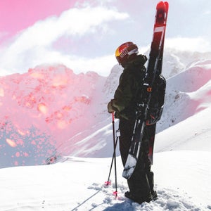 Skier Max Palm standing on snowy hill with Armada Antimatter skis on pack looking out over Silverton mountains