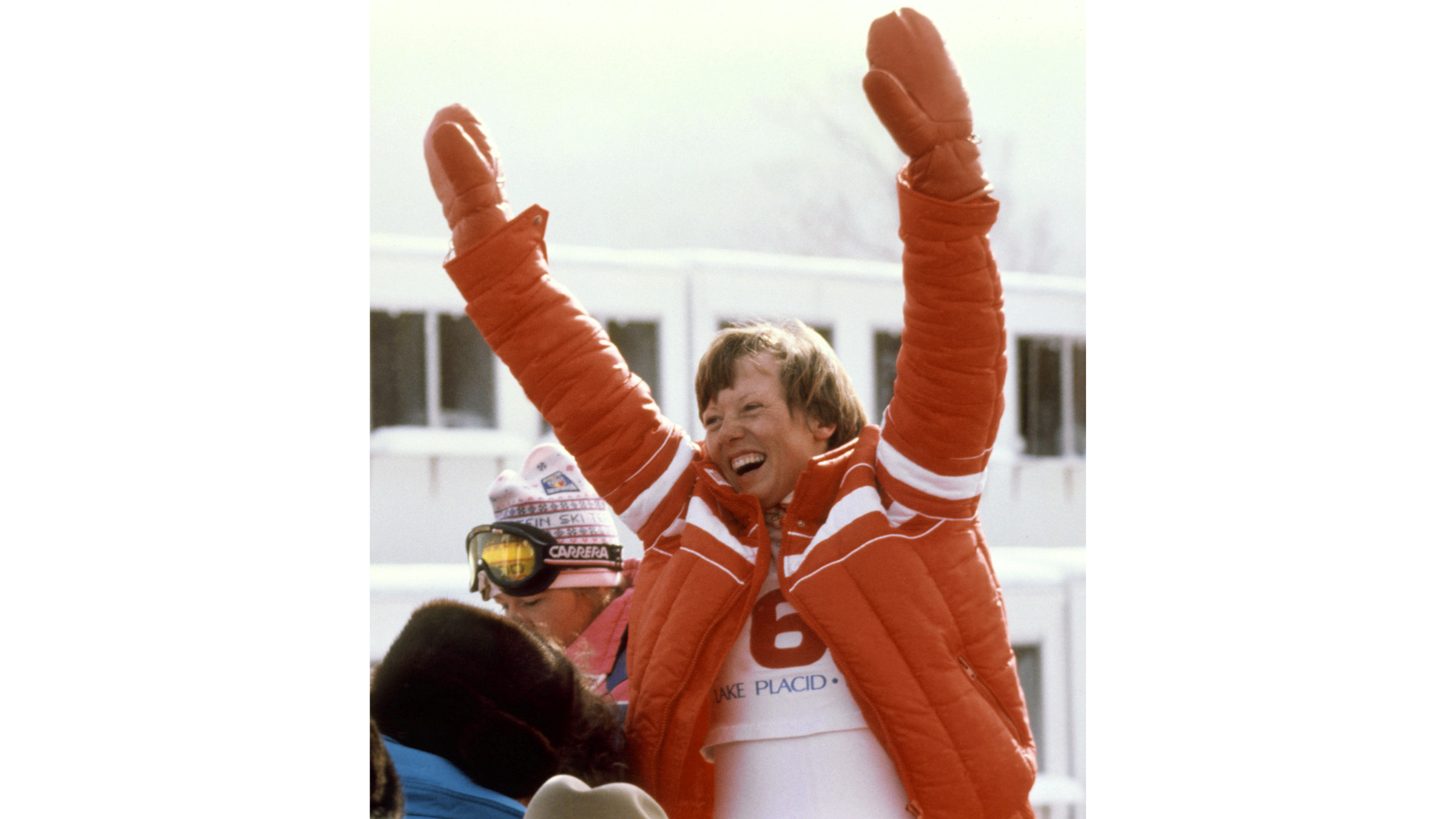 Austrian skier Annemarie Moser-Proell celebrates her 1980 downhill victory wearing a bright red quilted puffer jacket, a key piece of winter gear that utilized Eddie Bauer's patented goose-down insulation.