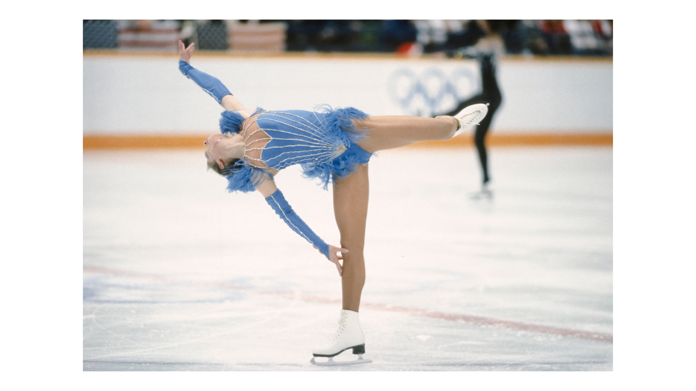 Katarina Witt performs in her 1988 Olympics high-cut blue feathered dress, a costume that led to new regulations regarding athletic coverage.