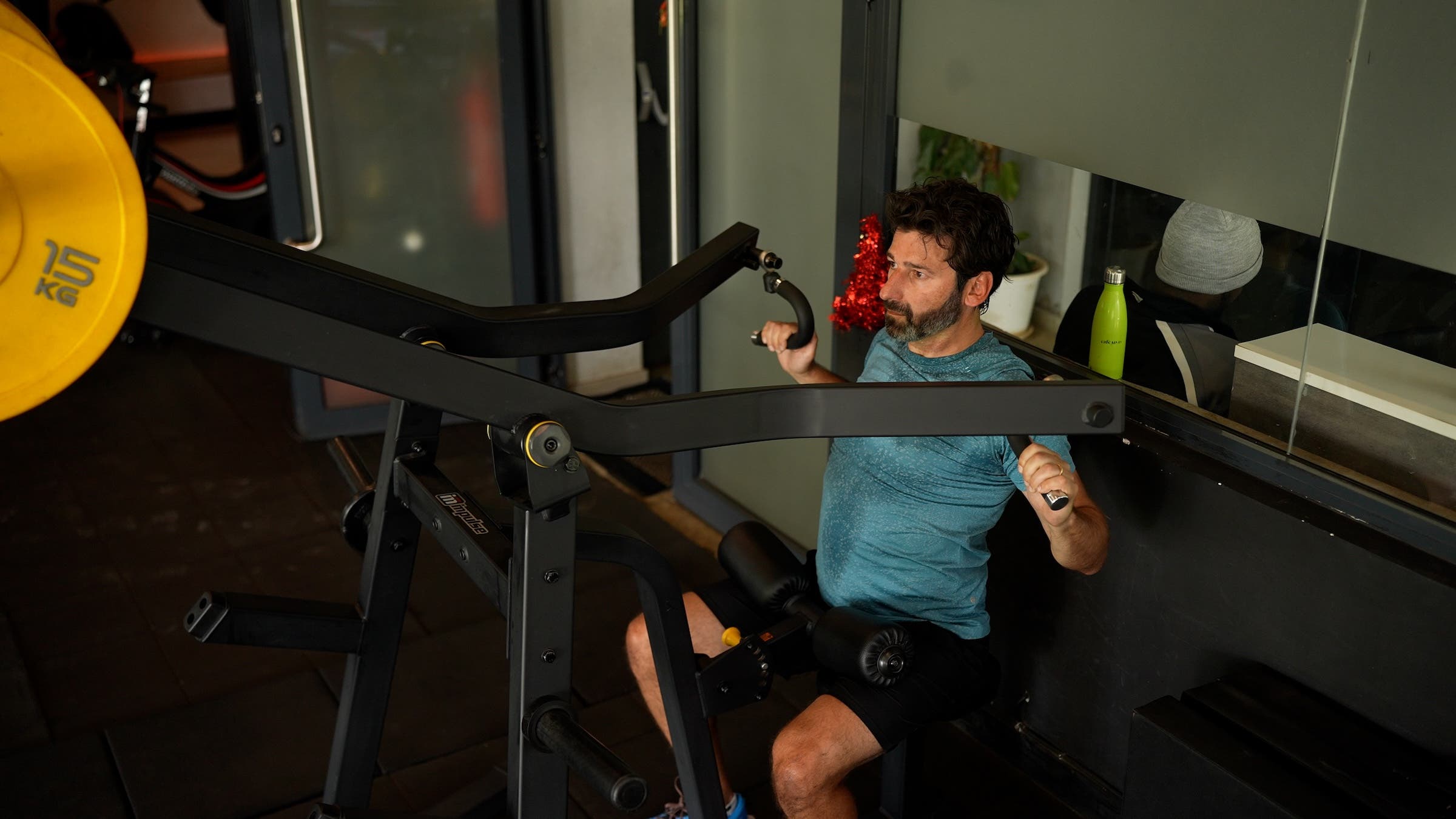 A man performs a lat pulldown