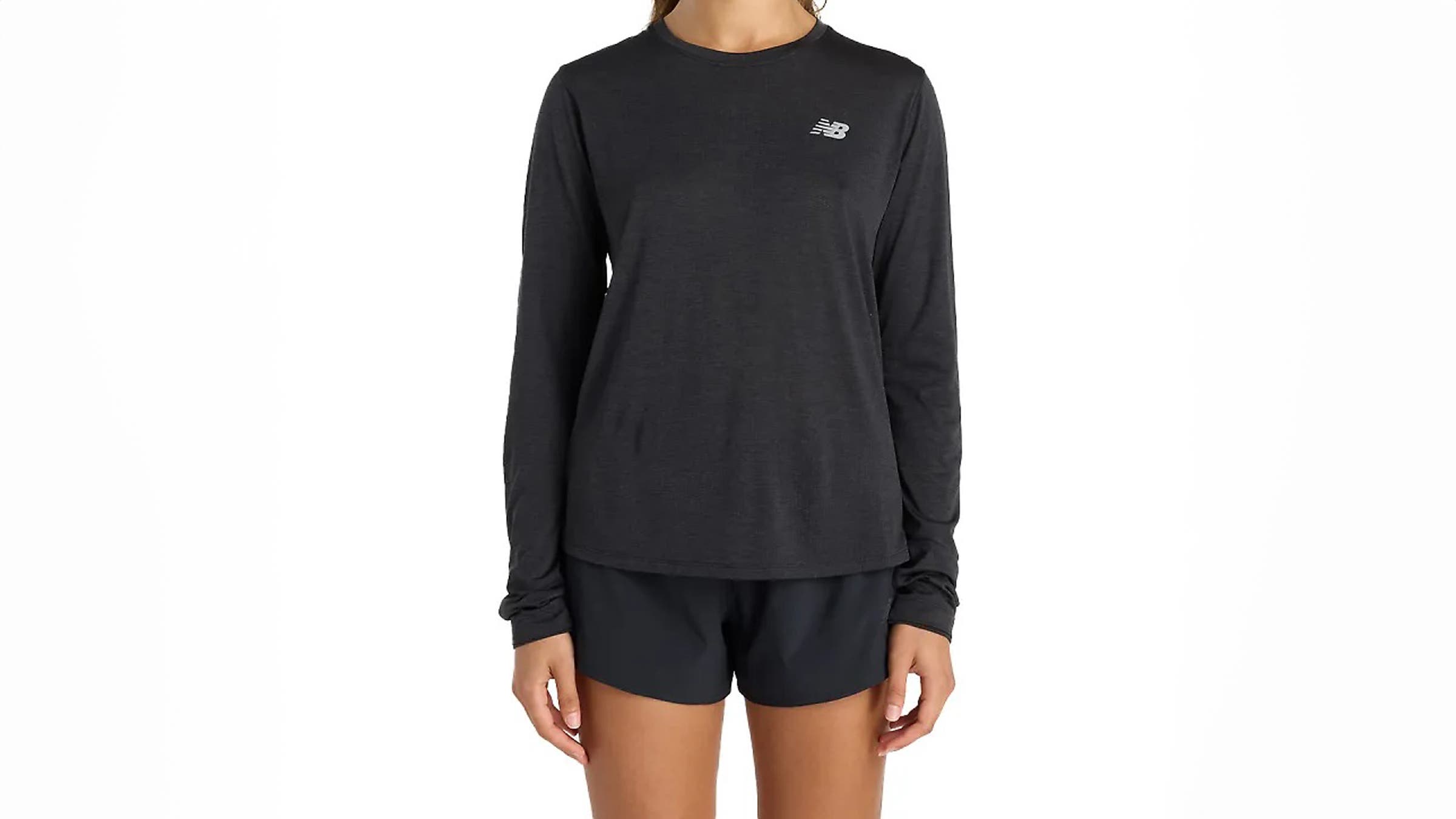 New Balance Athletics Long Sleeve running layer in black, featuring a lightweight textured fabric, quarter-zip neckline, long sleeves with thumbholes, and a streamlined athletic fit designed for breathable warmth and everyday runs.