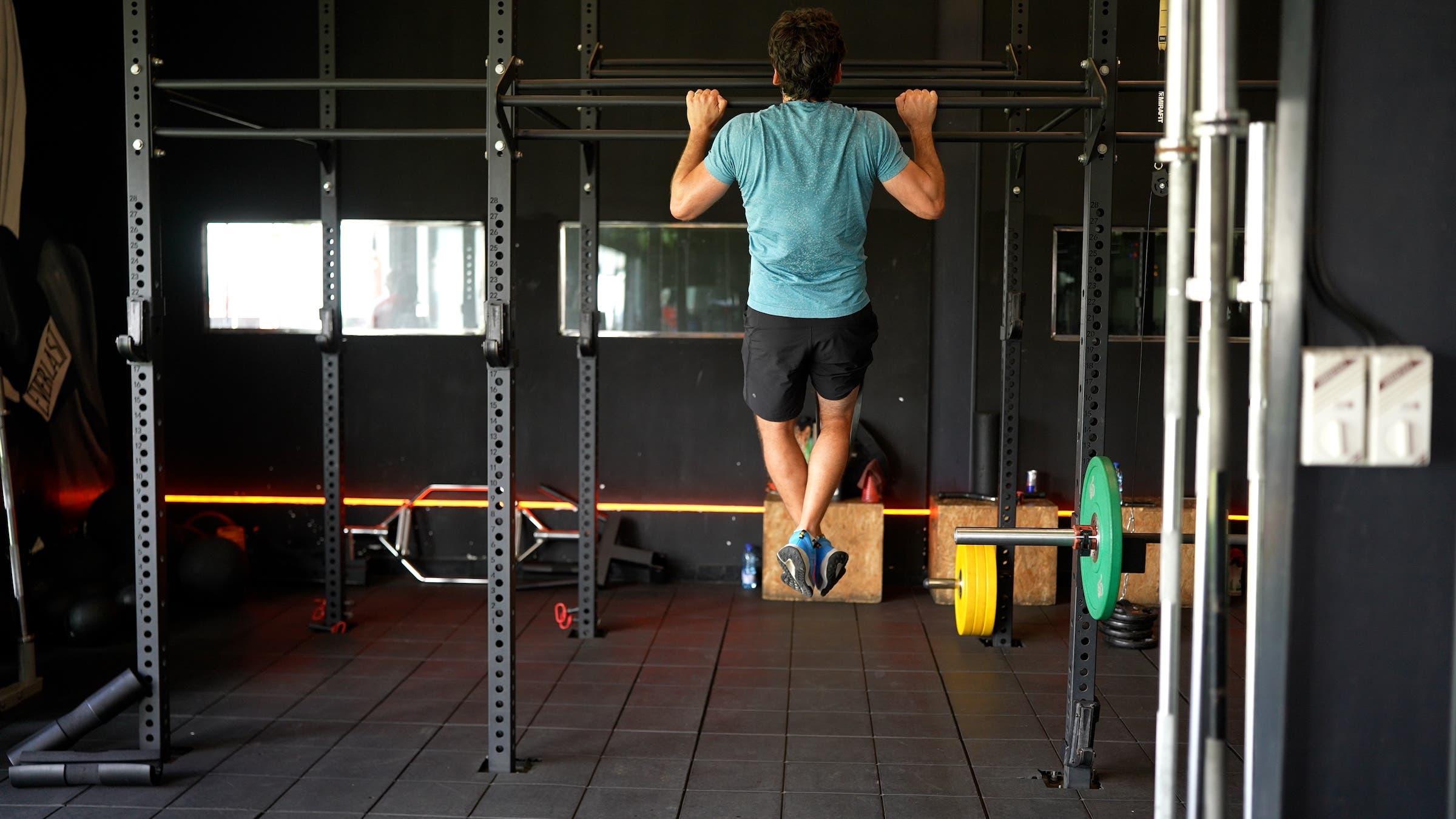 A man performs a pull-up using a resistance band