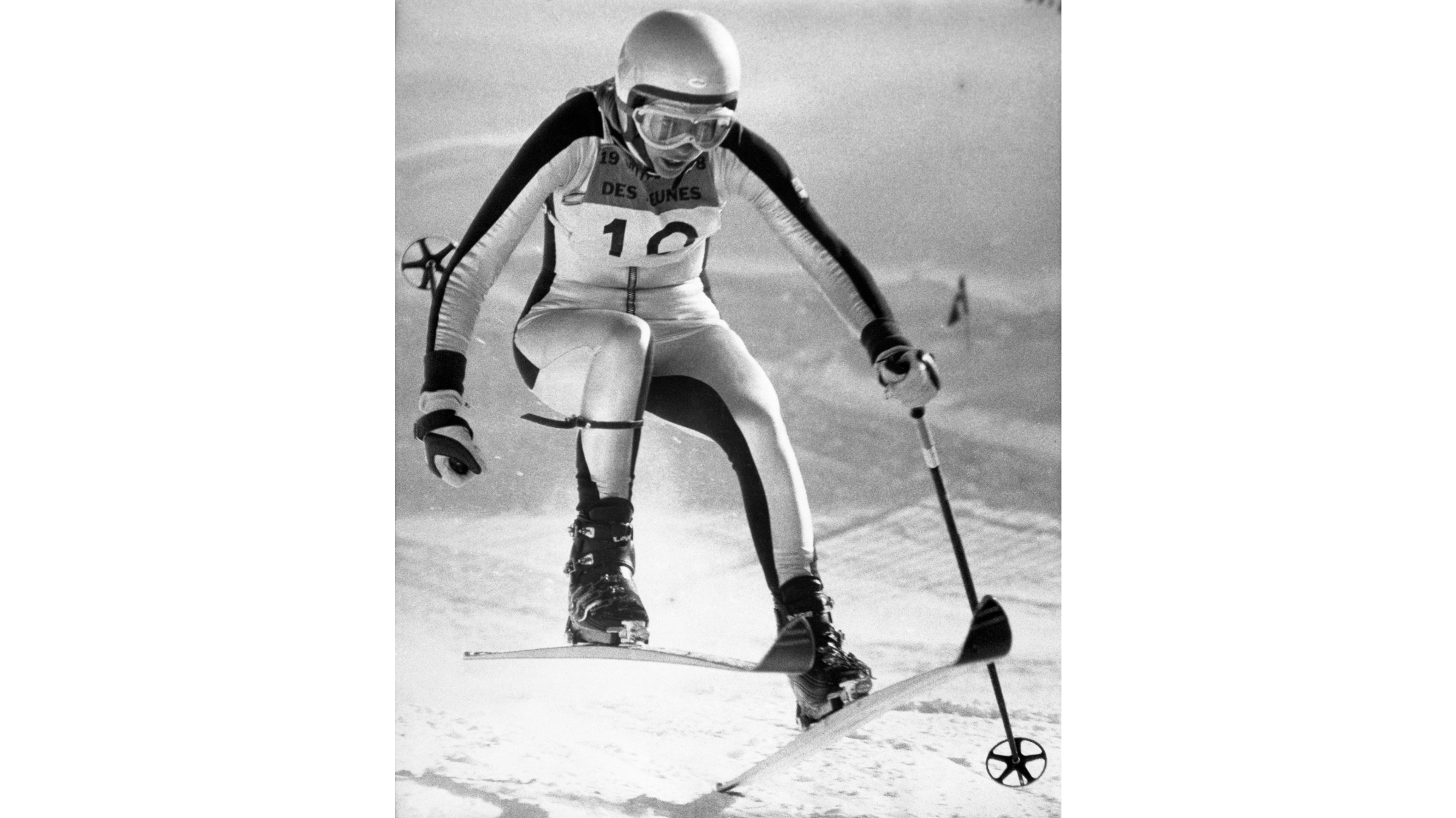 American downhill skier Suzy Chaffee poses in her eye-catching winter olympics gear from the 1968 Grenoble Games, a sleek, aerodynamic silver speed suit designed by Dick Burton.