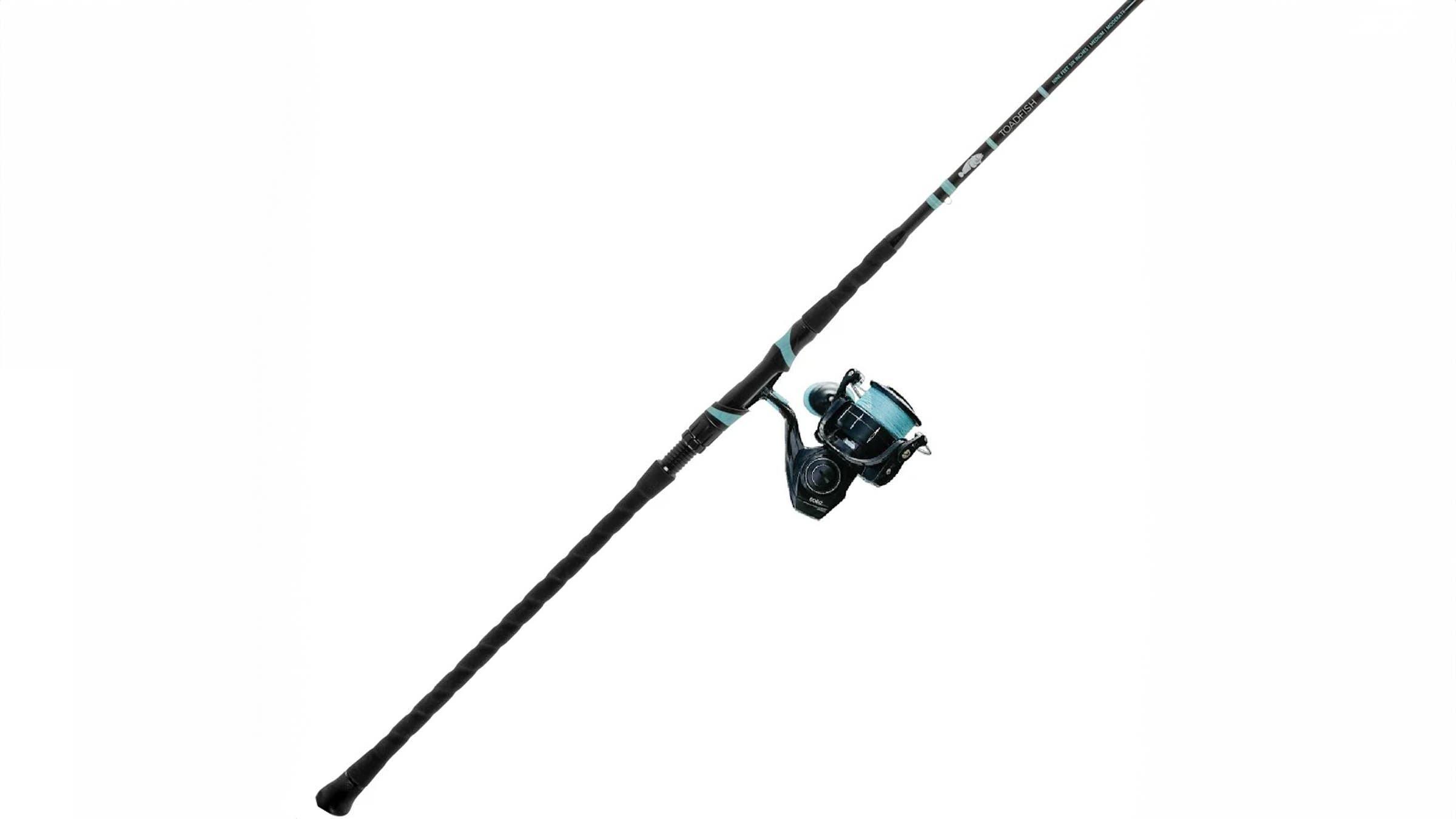 Toadfish Carbon Elite Surf Combo – 10’6” Medium Heavy Surf Rod – 6000 fishing rod and spinning reel with long black carbon rod, textured grip, and teal-accented reel, displayed diagonally on a white background.