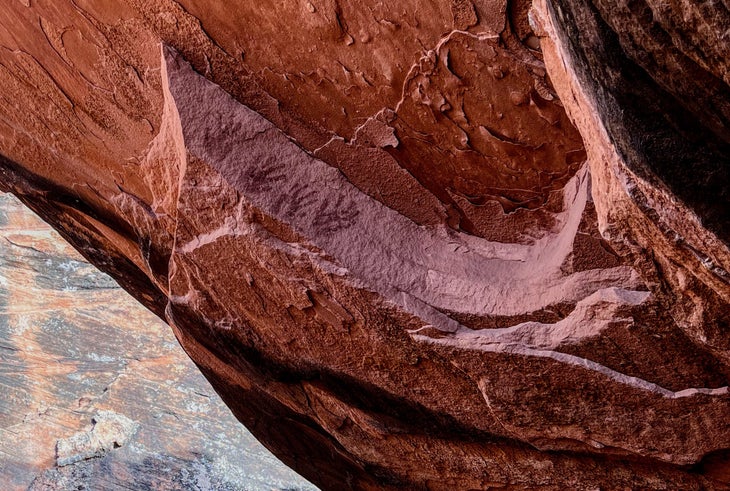 four handprints on red rock