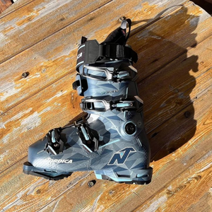 Closeup of Nordica Promachine 3 S 115 W ski boot on wooden table
