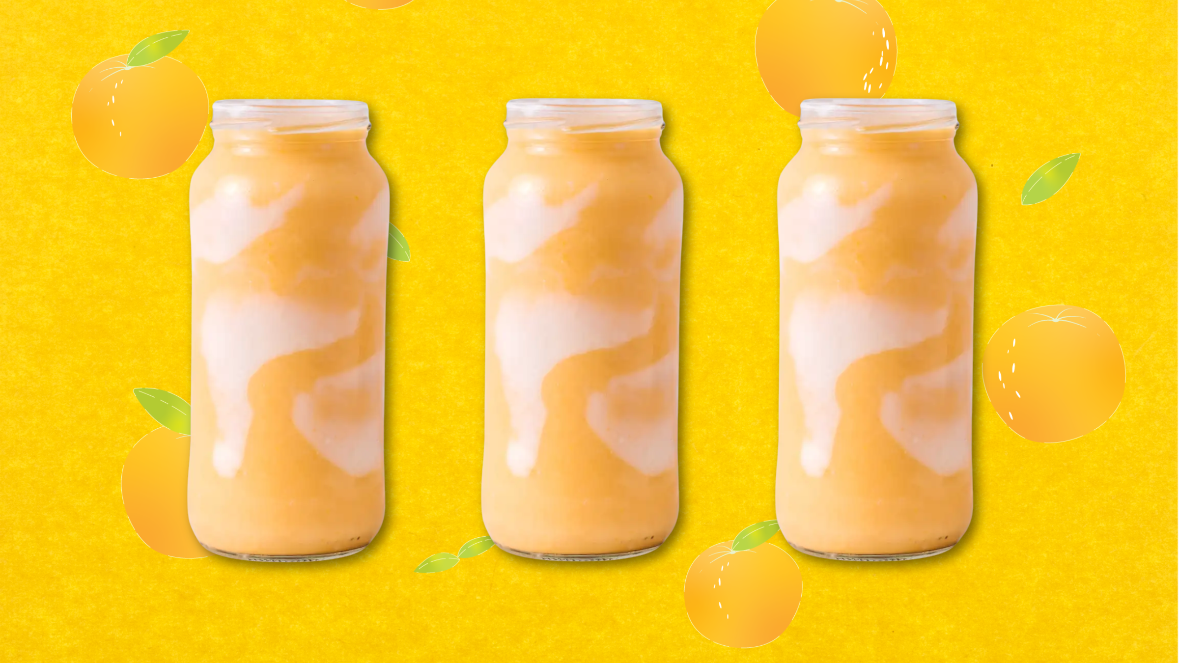 orange julius smoothie on an orange background with oranges floating around