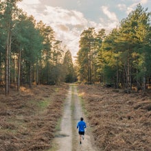 man running through woods