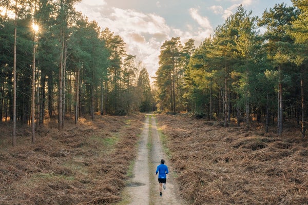 man running through woods