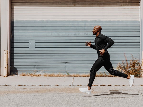 man running in black on pavement