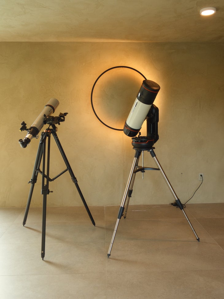 two telescopes against a limewash wall at Reset Hotel Joshua Tree