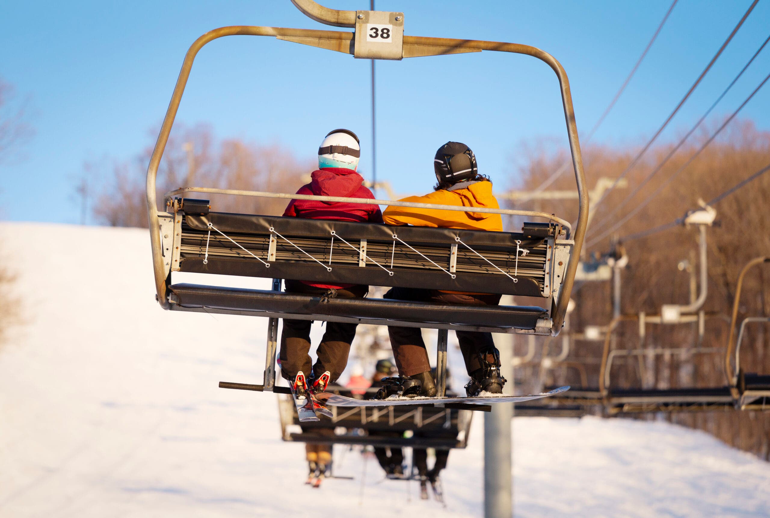 Skiers Couple on Chair Lift 