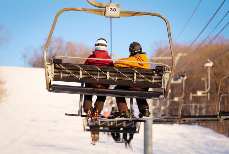 Skiers Couple on Chair Lift 