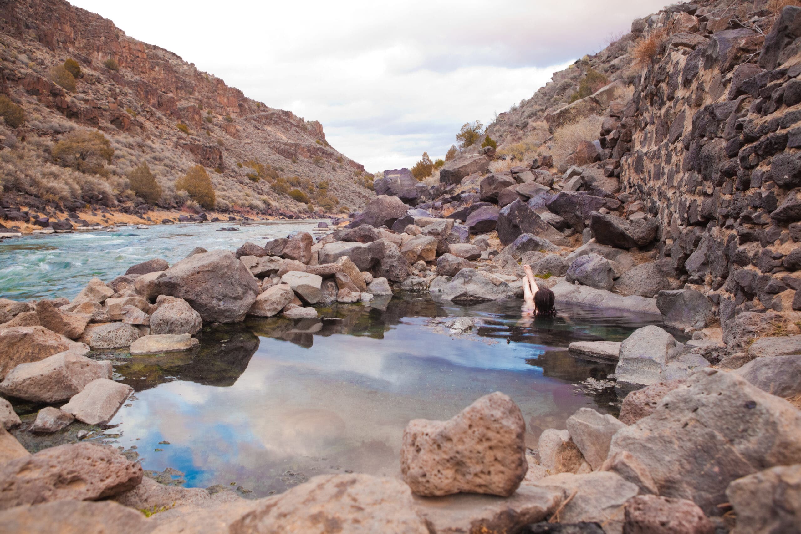 A woman soaking in natural hot springs