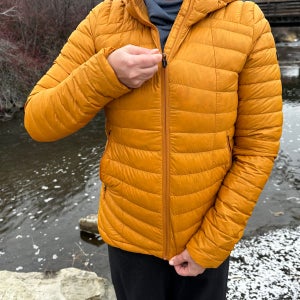Decathlon Simond MT100 Down Puffer jacket zipping up in front of stream.