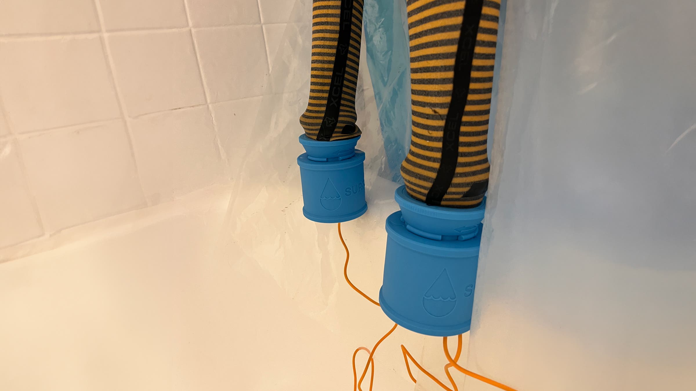 SurfDry wetsuit dryer being used in the shower to dry wetsuit.