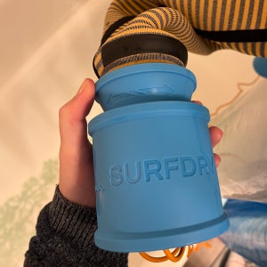 SurfDry wetsuit dryer being used in the shower to dry wetsuit.