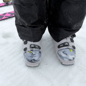 Bootcaps, low-tech toe warmers, on a skier standing on snow