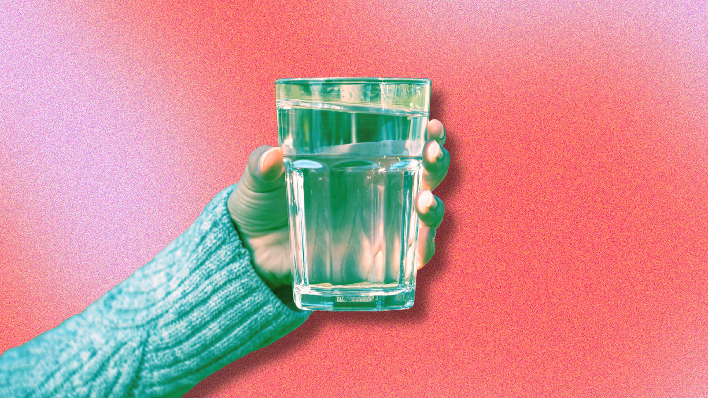 person holding a glass of water