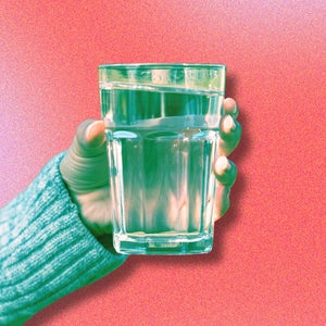 person holding a glass of water