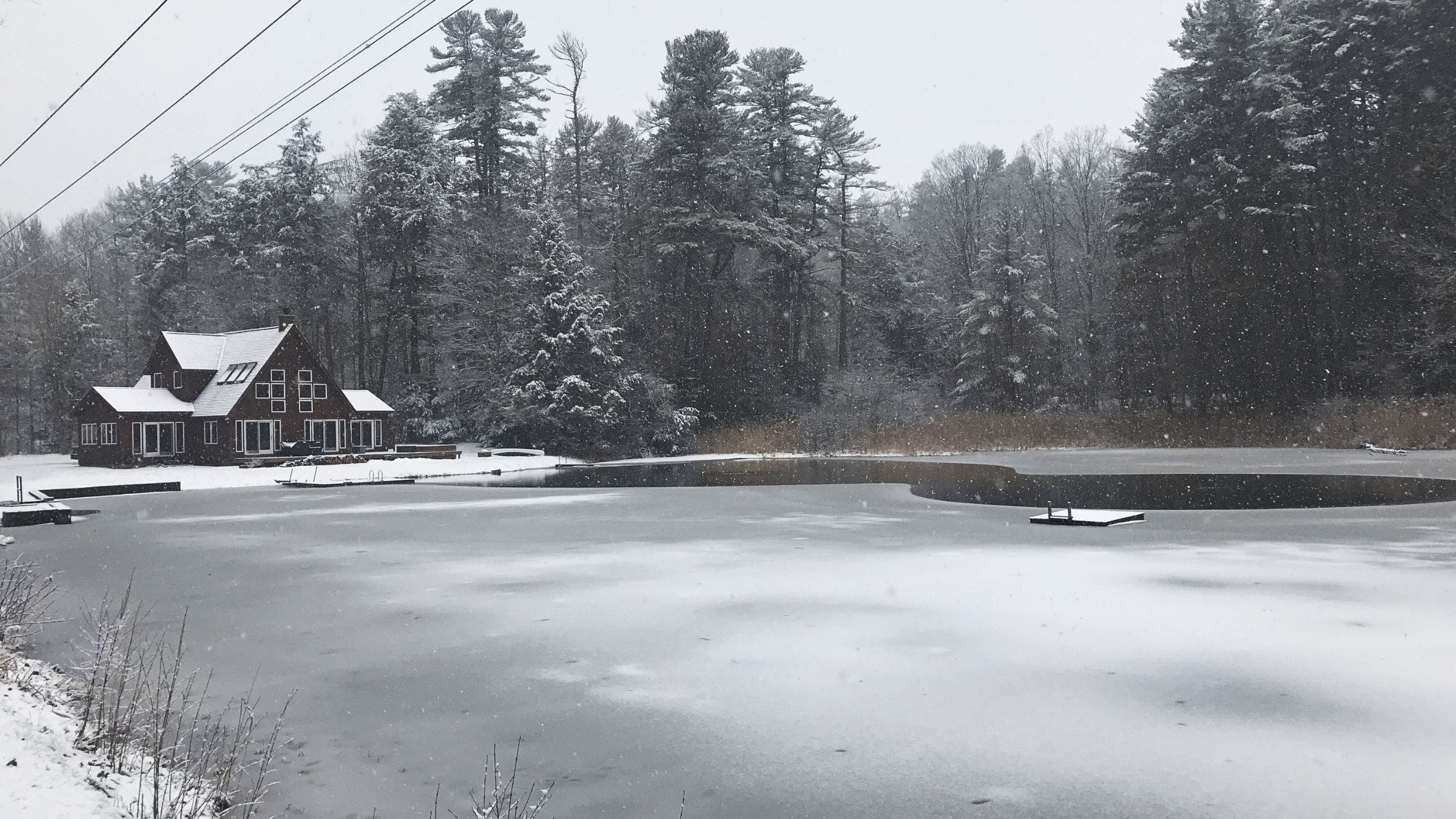 icy lake near a snow-covered cabin