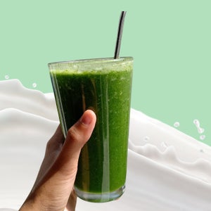 An image of a person holding a green, vegan, whole-food, protein-powder free smoothie