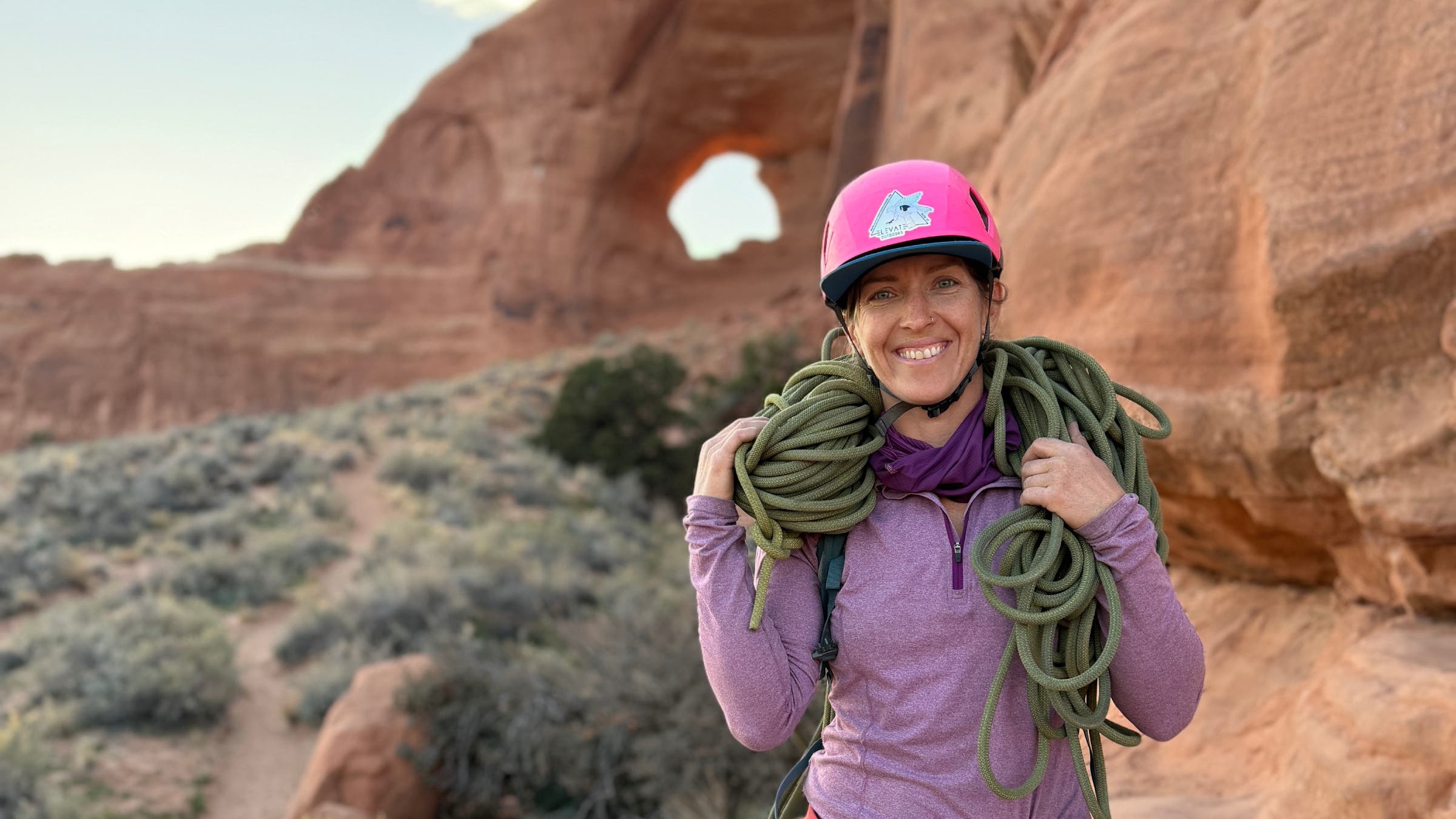 Faith Dickey in front of a red rock arch.